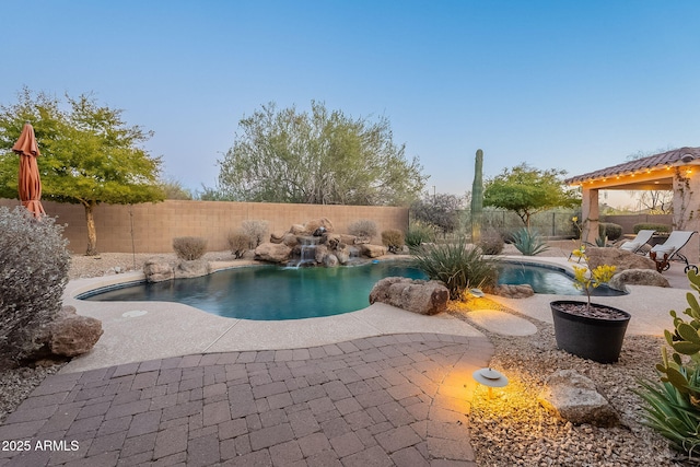 view of pool with pool water feature and a patio