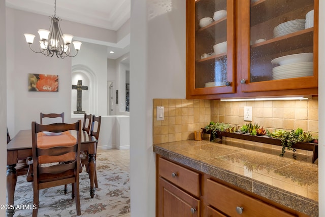 tiled dining room featuring a notable chandelier