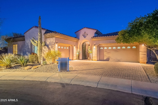 mediterranean / spanish house with a garage