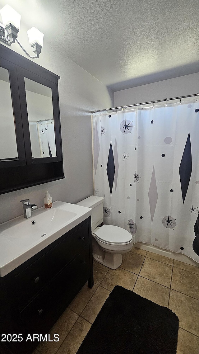 5751 W Muriel Dr, Glendale, AZ 85308 - bathroom featuring vanity, tile patterned flooring, a textured ceiling, and curtained shower