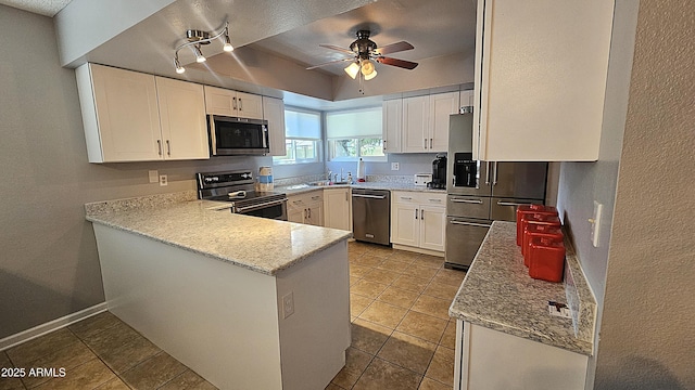5751 W Muriel Dr, Glendale, AZ 85308 - kitchen featuring appliances with stainless steel finishes, ceiling fan, a peninsula, white cabinets, and a textured wall