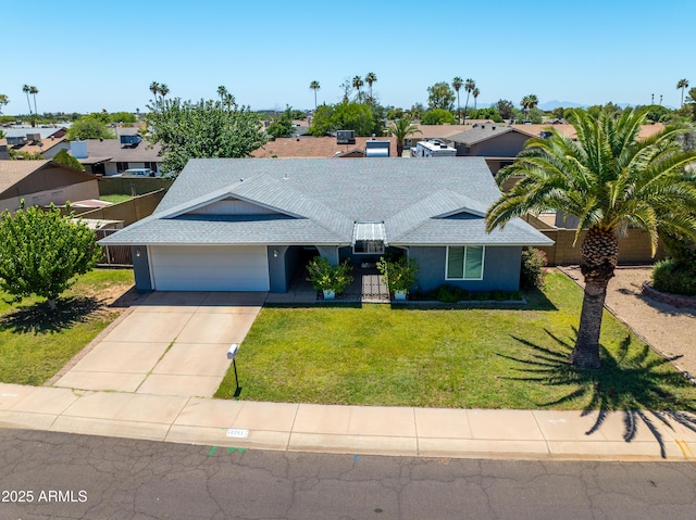 5751 W Muriel Dr, Glendale, AZ 85308 - single story home with an attached garage, concrete driveway, a front yard, a residential view, and roof with shingles