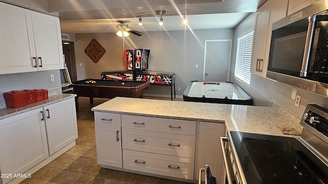 5751 W Muriel Dr, Glendale, AZ 85308 - kitchen featuring stainless steel appliances, a ceiling fan, light tile patterned floors, and white cabinets