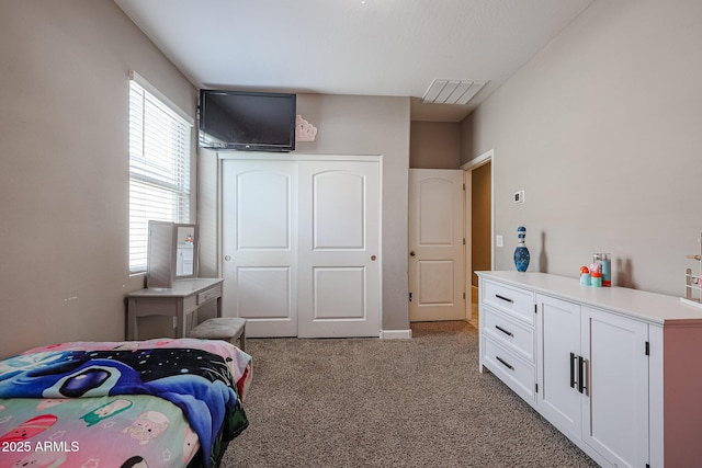 carpeted bedroom with a closet