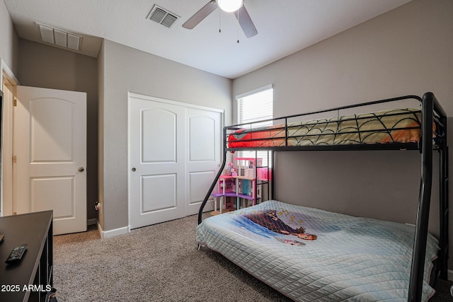 bedroom with ceiling fan, carpet flooring, and a closet