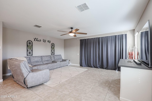 living room featuring ceiling fan and light tile patterned flooring