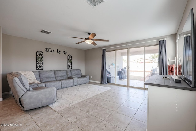 tiled living room featuring ceiling fan