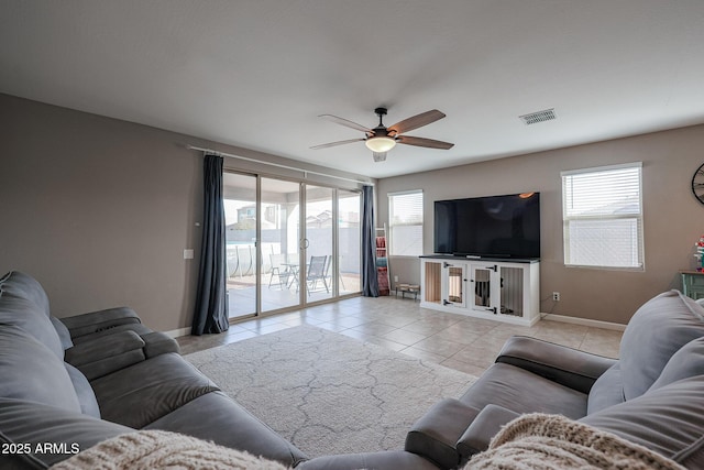 tiled living room featuring ceiling fan