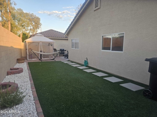 view of yard featuring a patio area and a gazebo