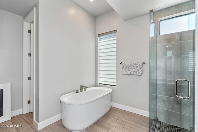 bathroom featuring a wealth of natural light and plus walk in shower