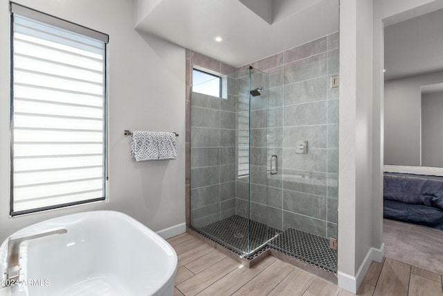 bathroom featuring separate shower and tub