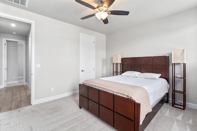 bedroom featuring ceiling fan and light carpet