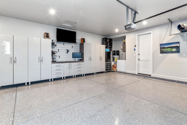 garage featuring a garage door opener and heat pump water heater