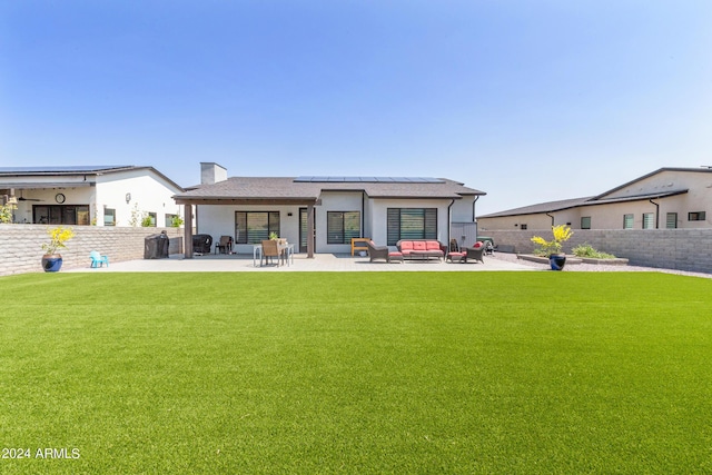 rear view of property with a patio area, outdoor lounge area, and a yard