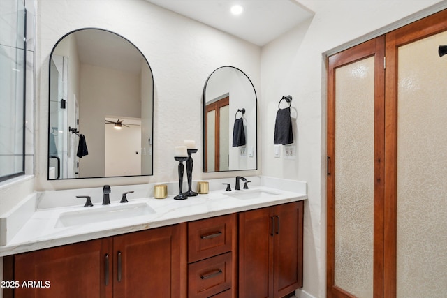 full bathroom with double vanity and a sink