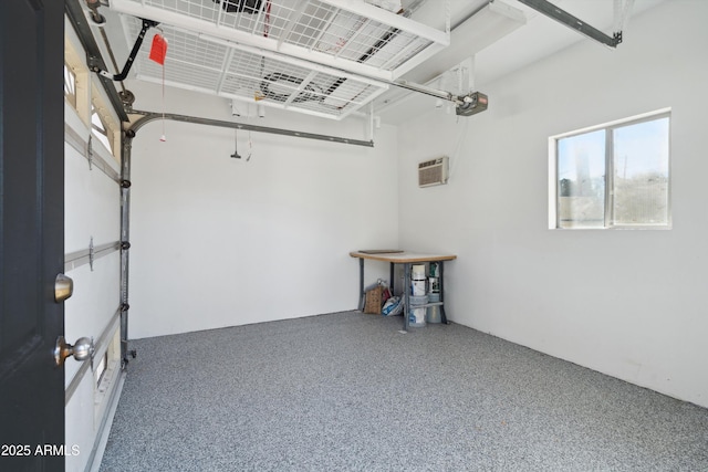 garage with a garage door opener and a wall mounted air conditioner