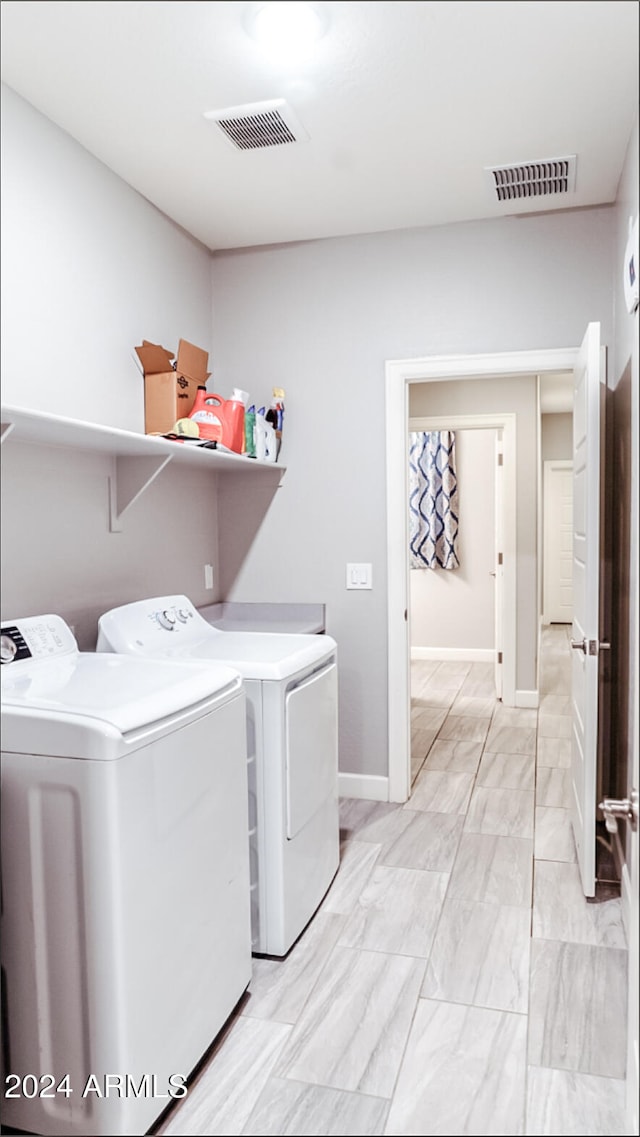 clothes washing area featuring washer and clothes dryer