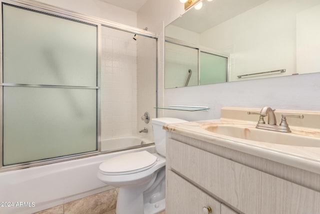 bathroom with combined bath / shower with glass door, toilet, and vanity