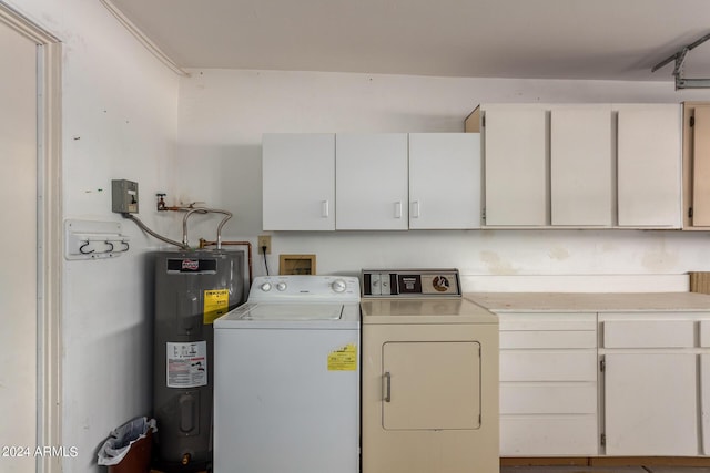 clothes washing area featuring water heater, separate washer and dryer, and cabinet space