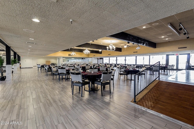 dining area with a textured ceiling and wood finished floors