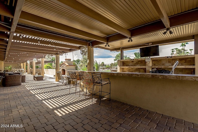 view of patio / terrace featuring outdoor dry bar and a pergola