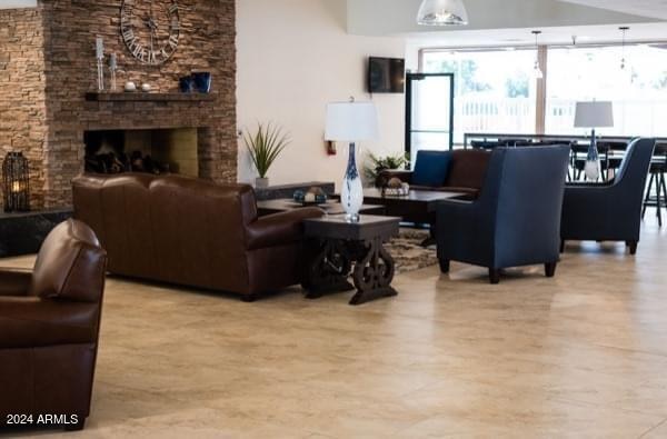 living room featuring a stone fireplace