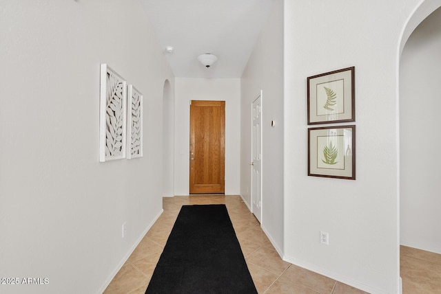 3026 W Silver Fox Way, Phoenix, AZ 85045 - hallway with arched walkways and light tile patterned flooring