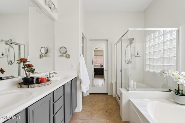 3026 W Silver Fox Way, Phoenix, AZ 85045 - bathroom featuring a shower stall, a bath, double vanity, and tile patterned flooring
