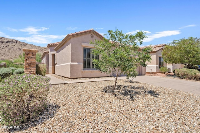 3026 W Silver Fox Way, Phoenix, AZ 85045 - view of front facade with stucco siding, driveway, a tiled roof, and an attached garage