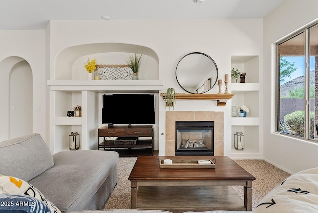 3026 W Silver Fox Way, Phoenix, AZ 85045 - living area with built in shelves and a tile fireplace