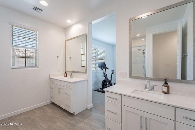 full bath with a wealth of natural light, a sink, and visible vents