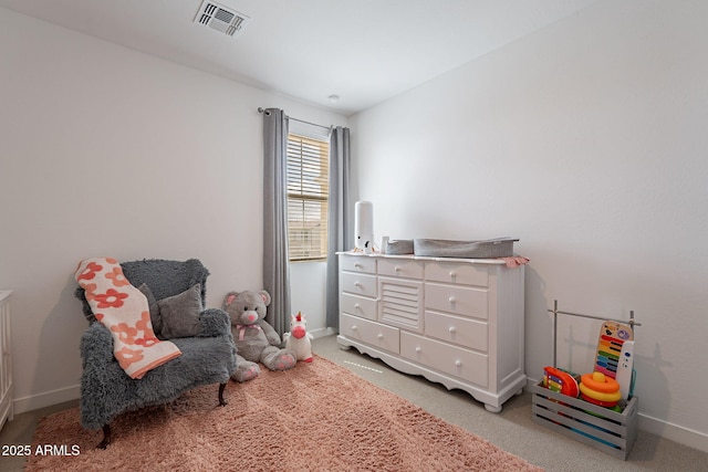 sitting room with visible vents, light carpet, and baseboards