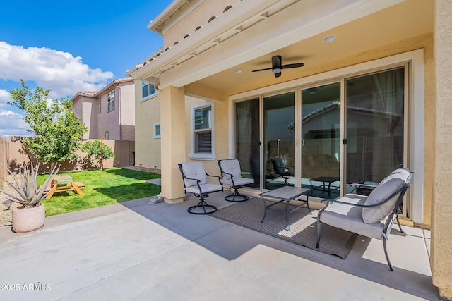 view of patio / terrace with a ceiling fan and fence