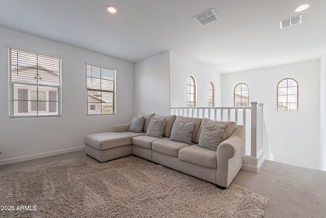 carpeted living room featuring recessed lighting, visible vents, and baseboards