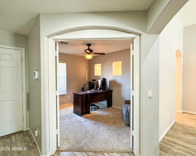 office space with light wood-type flooring and ceiling fan