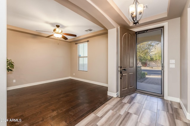 entryway with ceiling fan with notable chandelier and light wood-type flooring