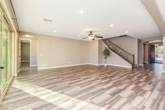 unfurnished living room featuring ceiling fan and light wood-type flooring