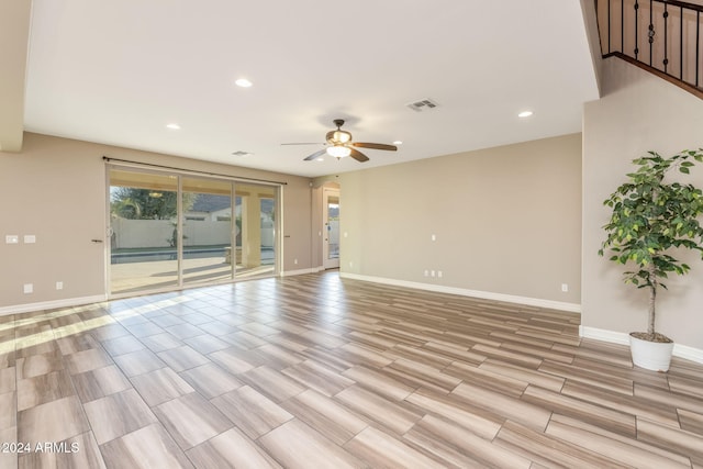 spare room featuring light hardwood / wood-style flooring and ceiling fan