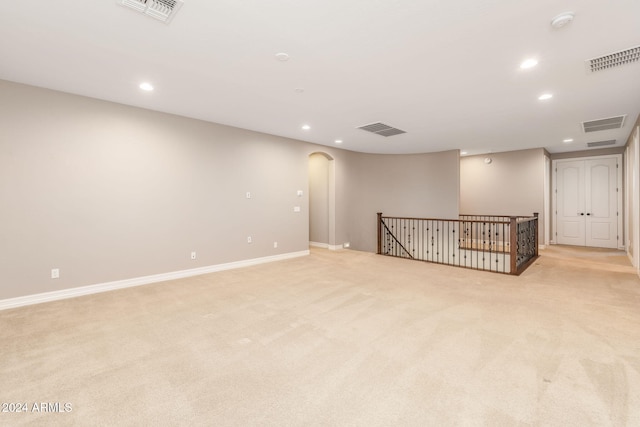 basement featuring light carpet