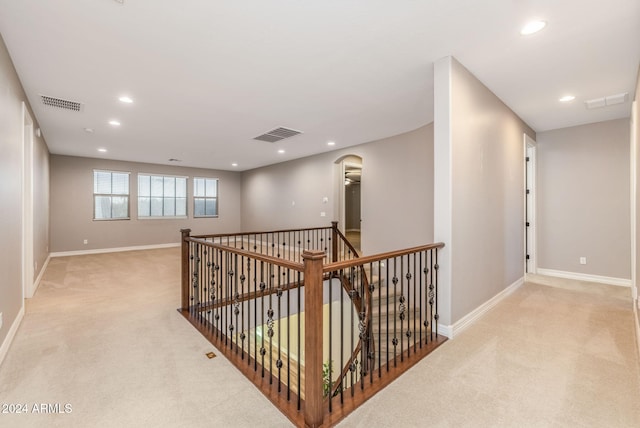 corridor with light colored carpet