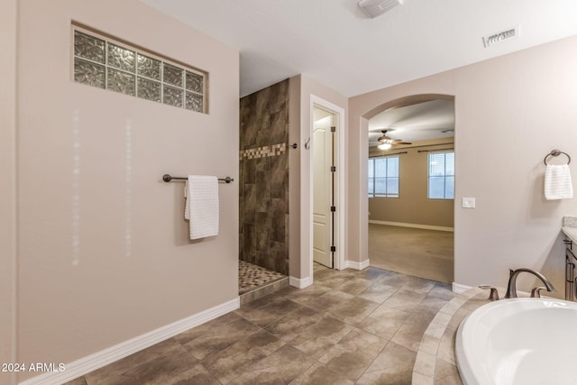 bathroom featuring vanity, ceiling fan, plus walk in shower, and tile patterned flooring