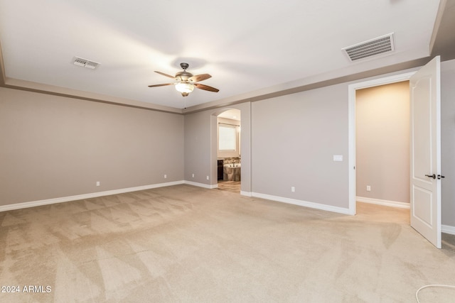 carpeted spare room featuring ceiling fan