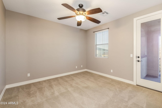 unfurnished room with light carpet and ceiling fan