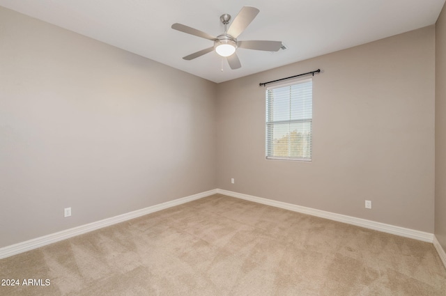 unfurnished room featuring light carpet and ceiling fan