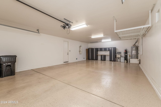 garage featuring water heater, a garage door opener, and gas water heater