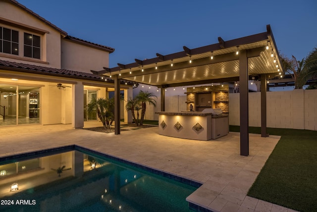 exterior space featuring a patio, a pergola, and exterior kitchen