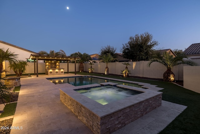 pool at dusk featuring an in ground hot tub and a patio area