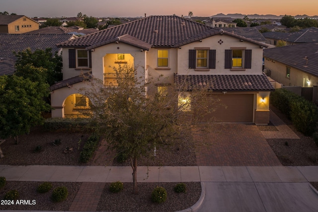 mediterranean / spanish house featuring a garage