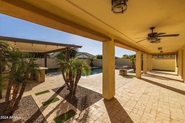 view of patio / terrace featuring ceiling fan and a fenced in pool