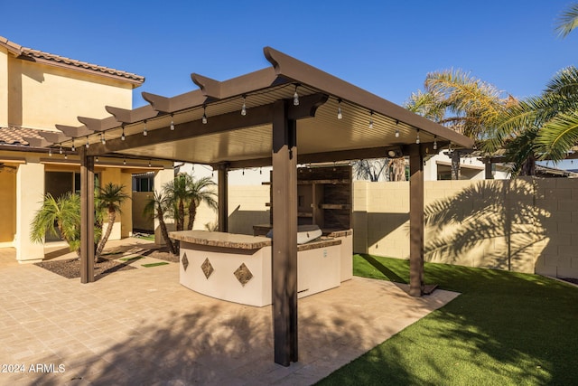 view of patio featuring an outdoor bar, a pergola, and area for grilling